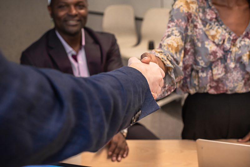 Business man shake hands with business women agreeing on partner