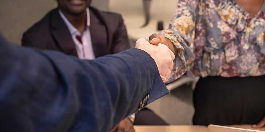 Business man shake hands with business women agreeing on partner