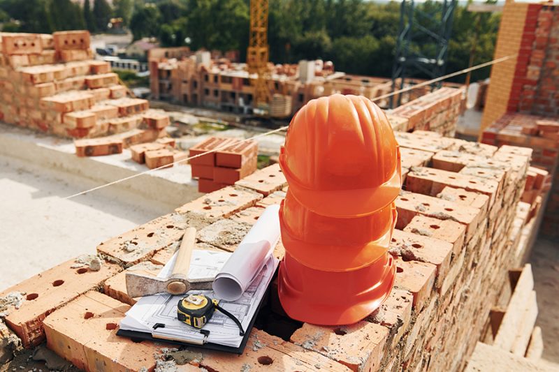 Close up view of protective hard hats that laying down on the bricks