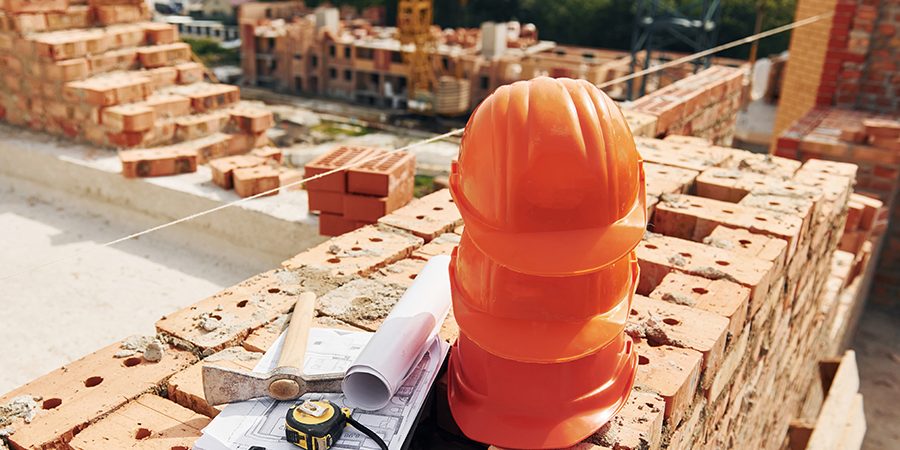 Close up view of protective hard hats that laying down on the bricks