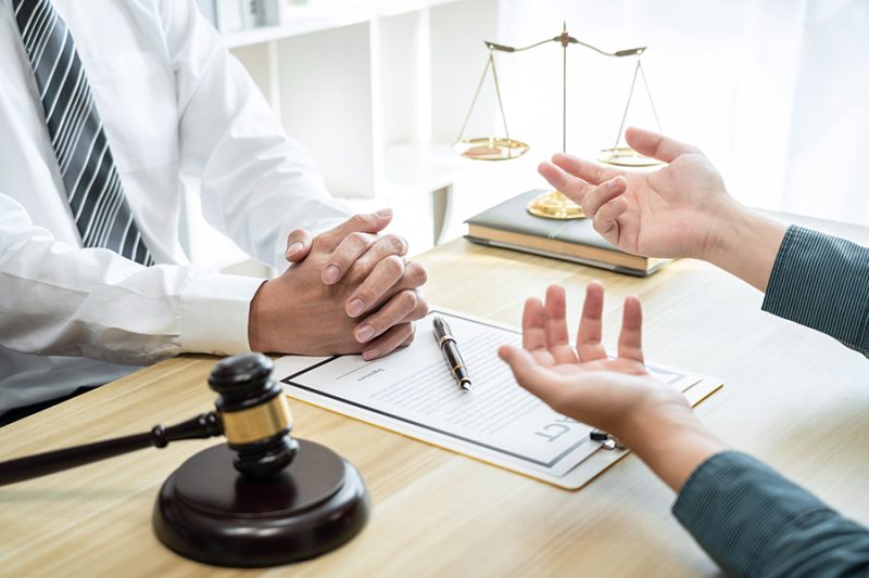 Male lawyer counselor are meeting with client to discuss consult